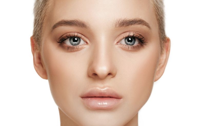 A woman's face with blue eyes and blond hair.