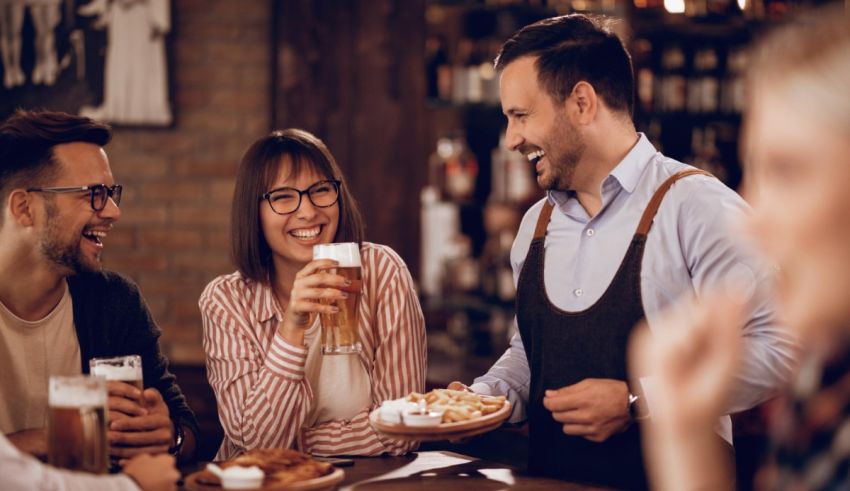 A group of people drinking beer at a bar.