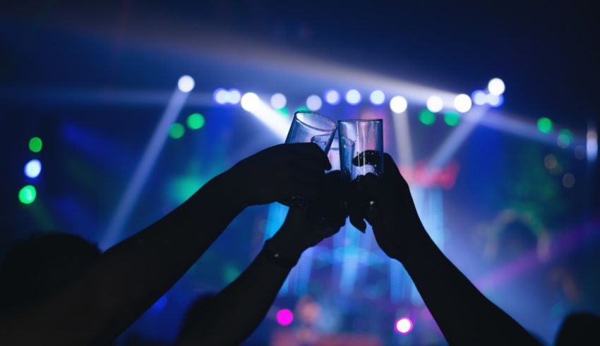 A group of people toasting at a concert.