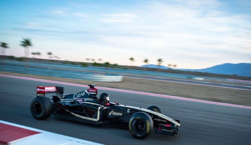 A black and gold racing car on a track.