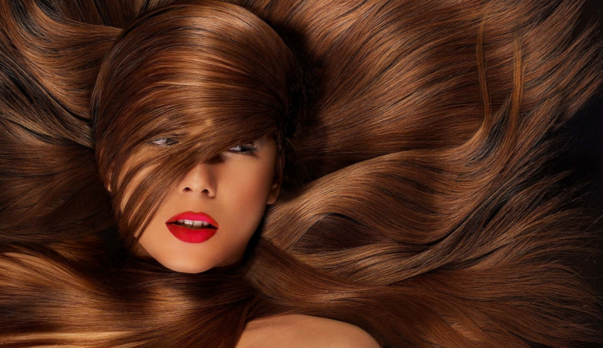 A woman with long brown hair is posing for a photo.