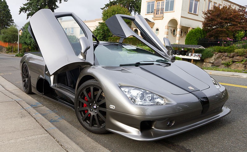A silver sports car parked on a street.