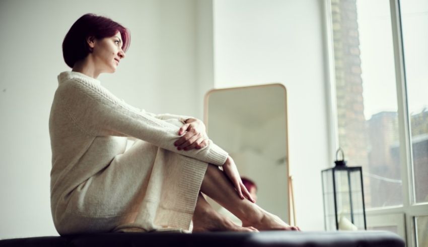A woman sitting in front of a window.