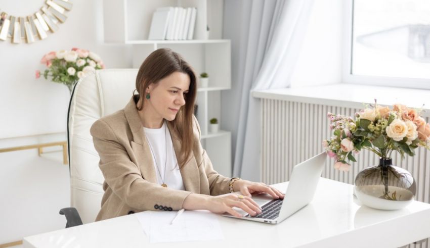 A business woman working on her laptop in her office.