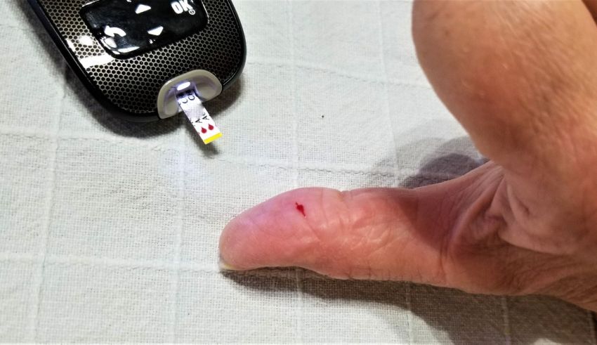 A person holding a remote to a finger.