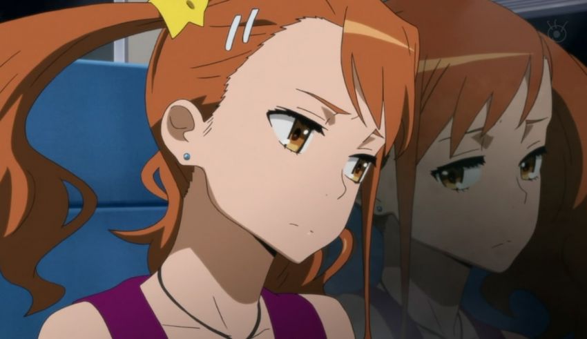 A girl is sitting in a train looking at her reflection.