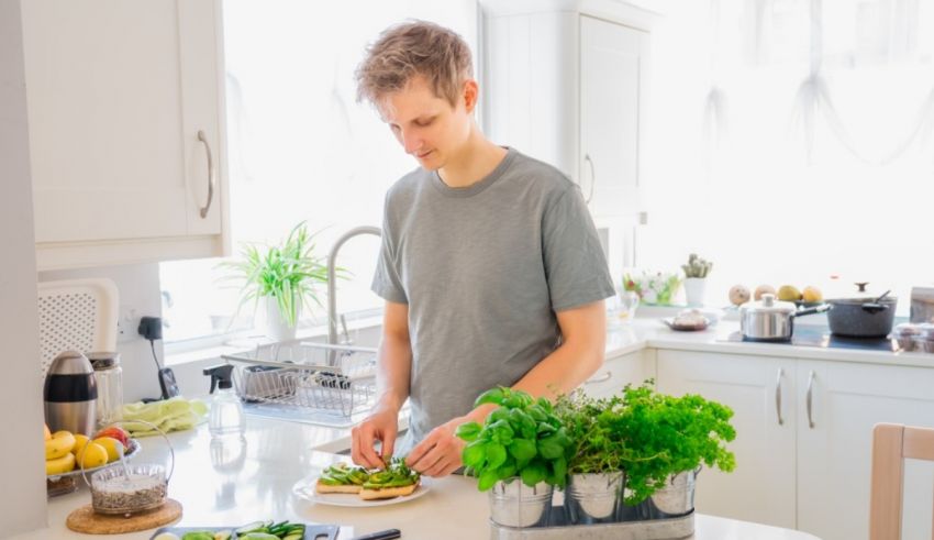 A young man is preparing food in the kitchen.