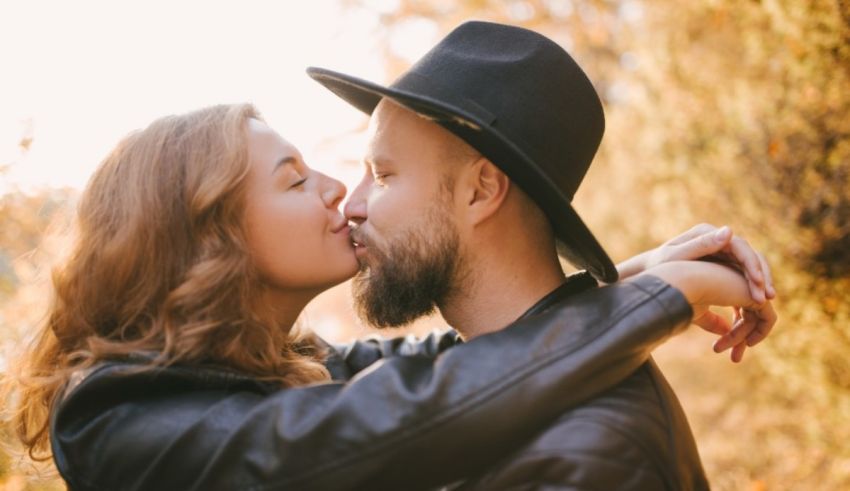 A man and woman kissing in the autumn.