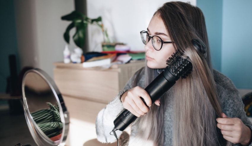 A woman is brushing her hair in front of a mirror.