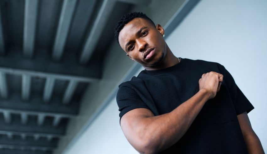 A young black man posing for a photo.