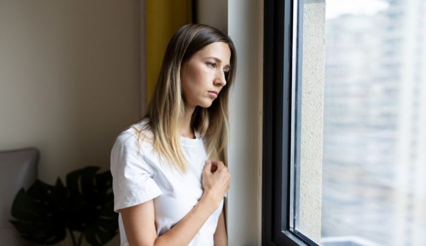 A young woman looking out of a window.