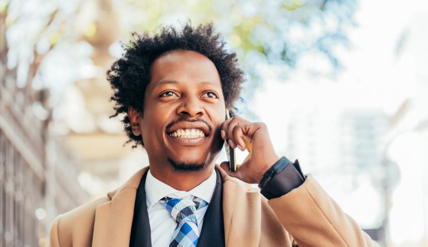 A man in a suit talking on a cell phone.