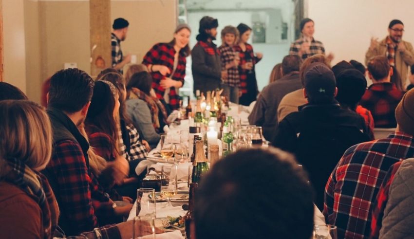 A group of people sitting at a table with candles.