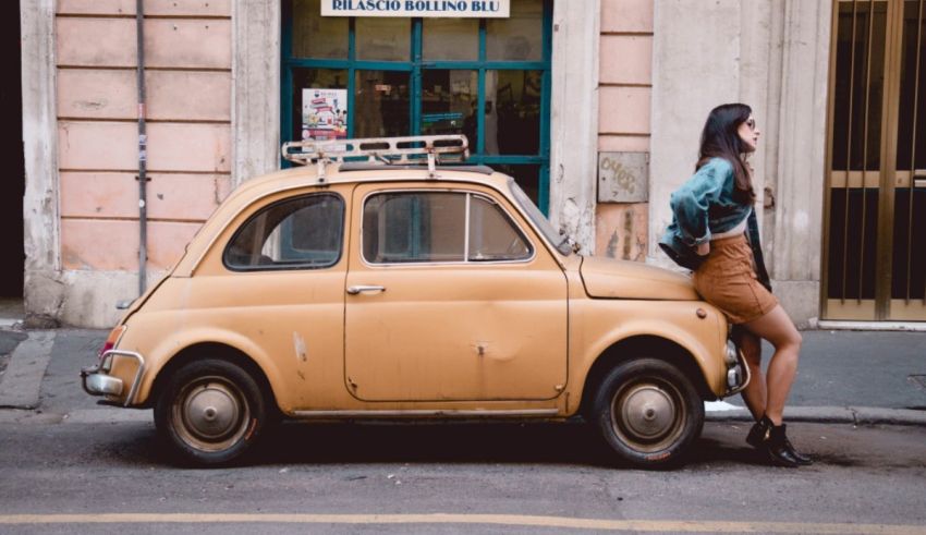 A woman leaning on the side of a yellow car.