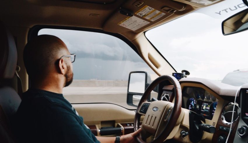A man sitting in the driver's seat of a truck.