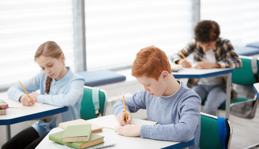A group of children are sitting at desks in a classroom.