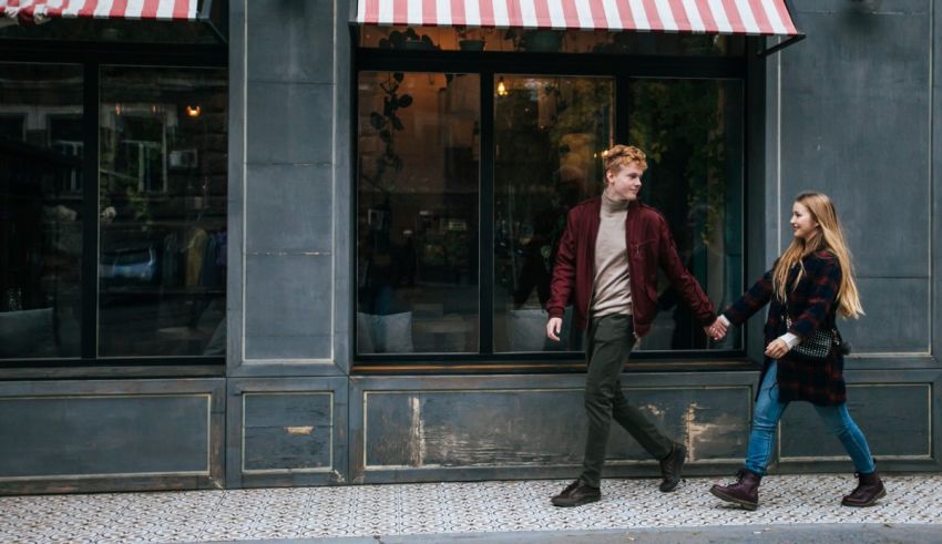 Two men walking on a sidewalk.
