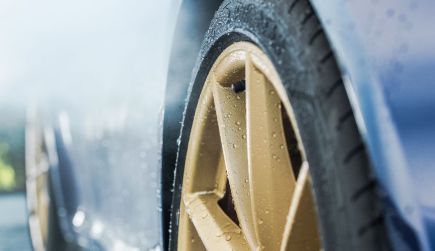 A close up of a car tire with water on it.
