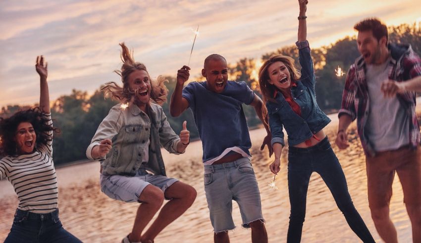 A group of friends jumping on a lake at sunset.