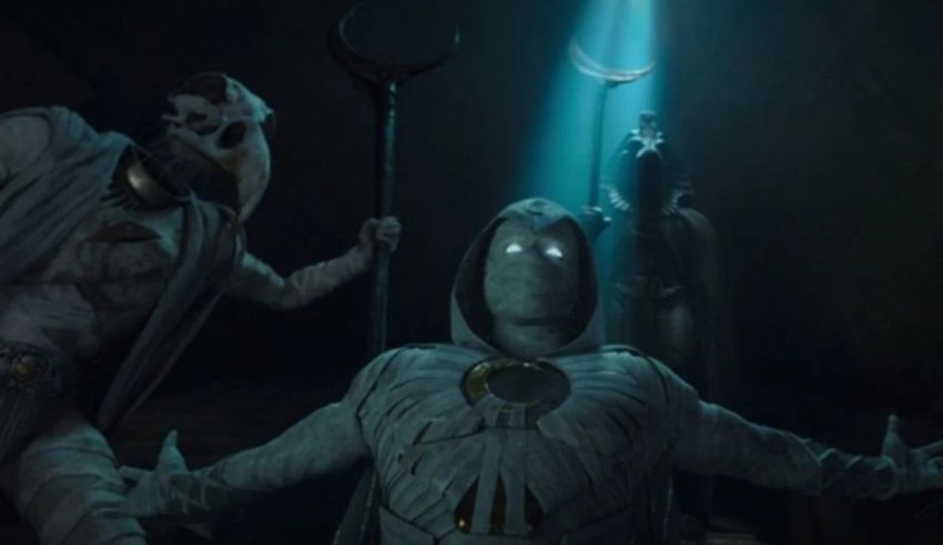 A group of people standing in a dark room.