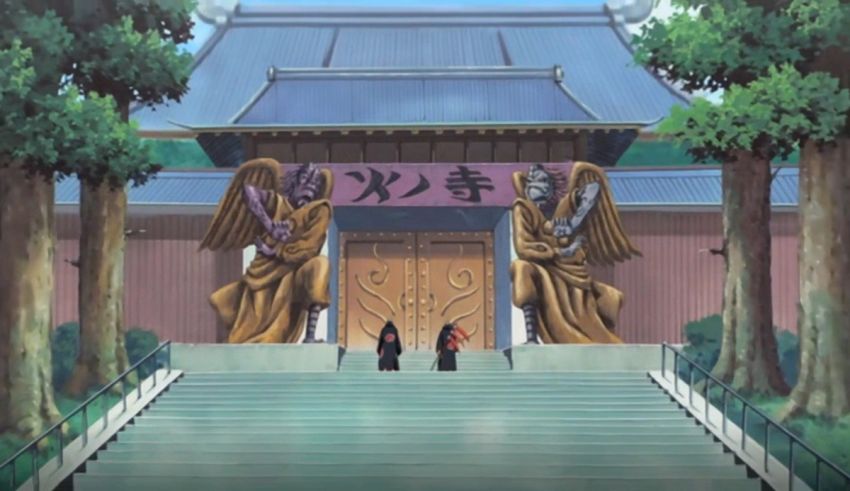 The entrance to a chinese temple with two statues in front of it.