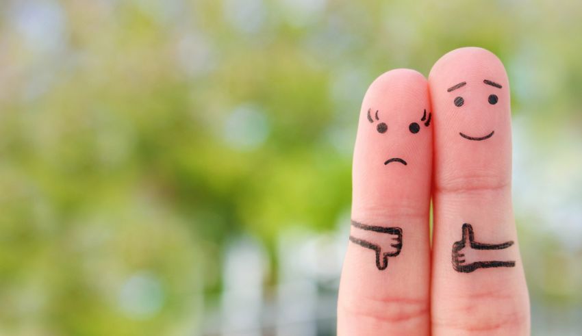 Two people with their fingers painted with a thumbs up and a thumbs down.