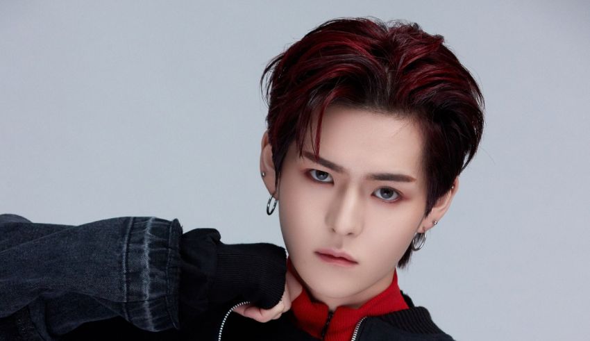 A young man with red hair posing for a photo.