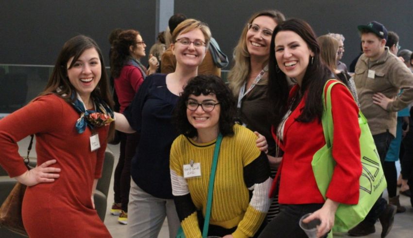 A group of women posing for a photo at an event.