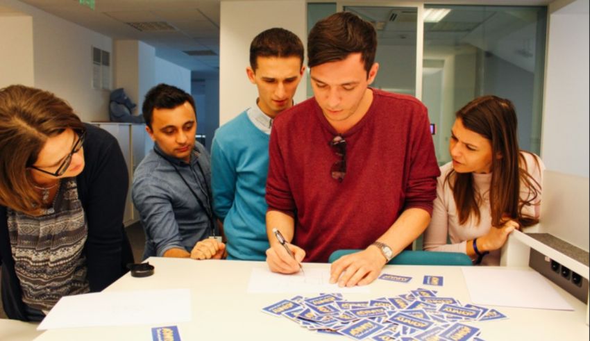 A group of people looking at a piece of paper.