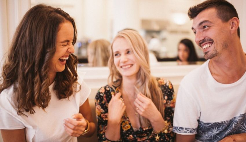 A group of friends laughing together in a restaurant.