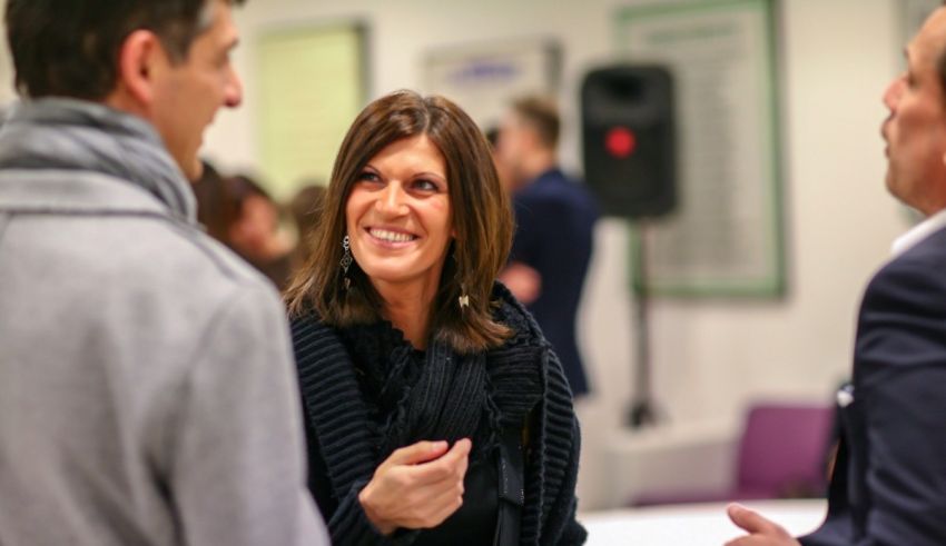 A group of people talking to each other at an event.