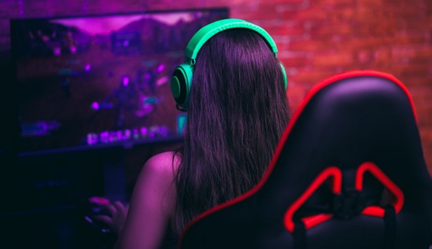 A woman wearing headphones and sitting in a chair.