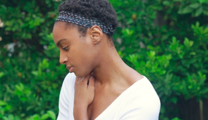 A black woman wearing a white shirt and a headband.