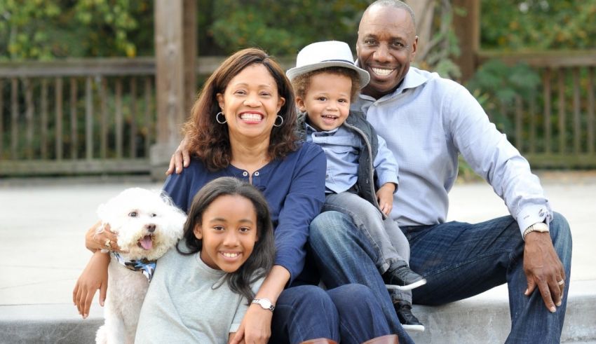 A family poses for a photo in a park.