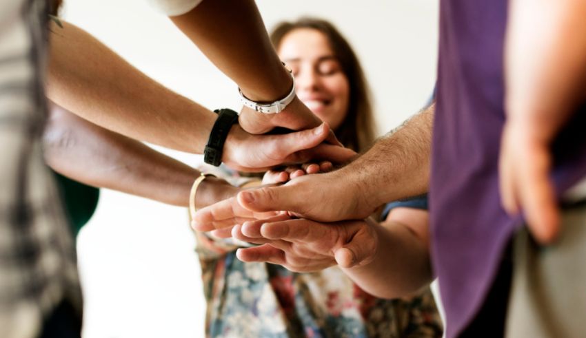 A group of people holding hands in a circle.
