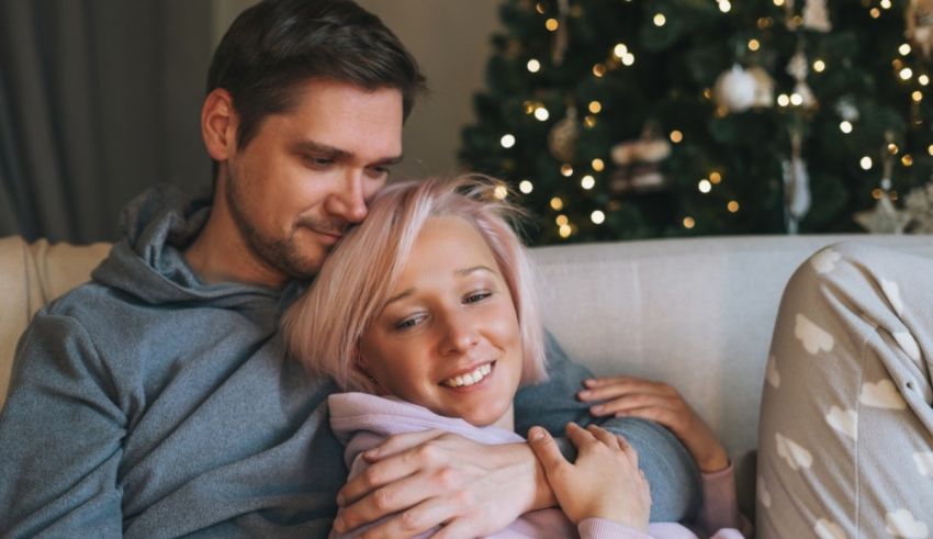 A man and woman sitting on a couch.