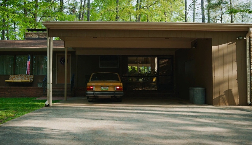 A car is parked in front of a house.