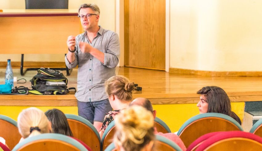 A man is giving a lecture to a group of people.
