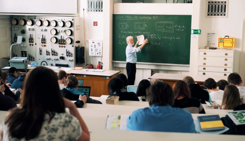 A teacher is giving a lecture in a classroom.