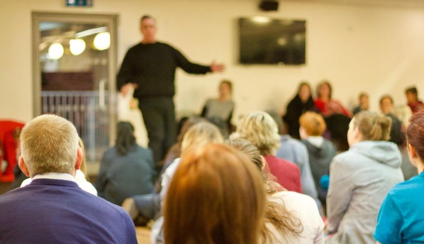 A man is giving a presentation to a group of people.