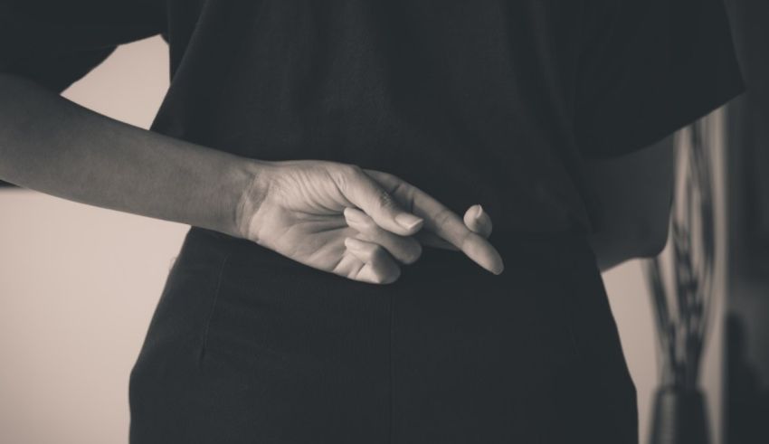 A black and white photo of a woman with her hand on her back.