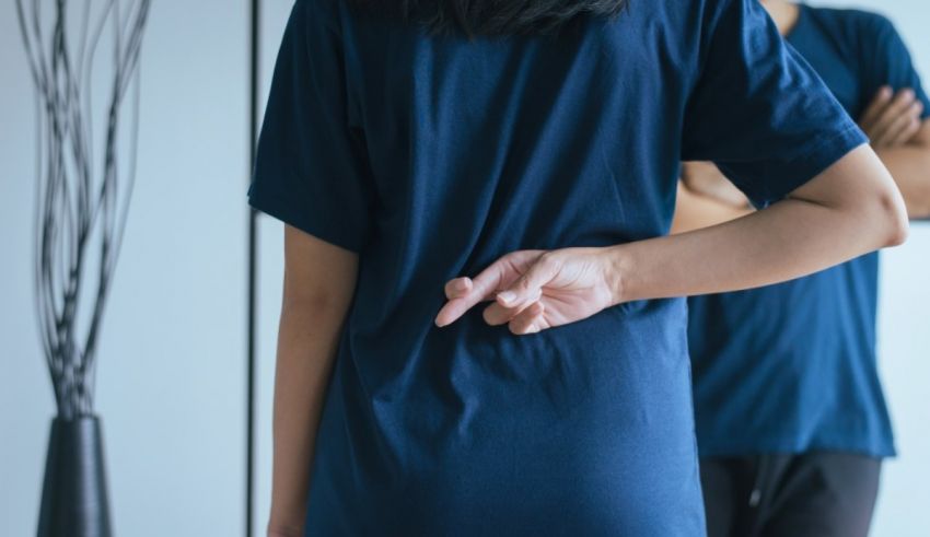 A man and woman standing in front of a mirror.