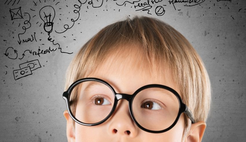 A young boy with glasses looking up at a drawing.