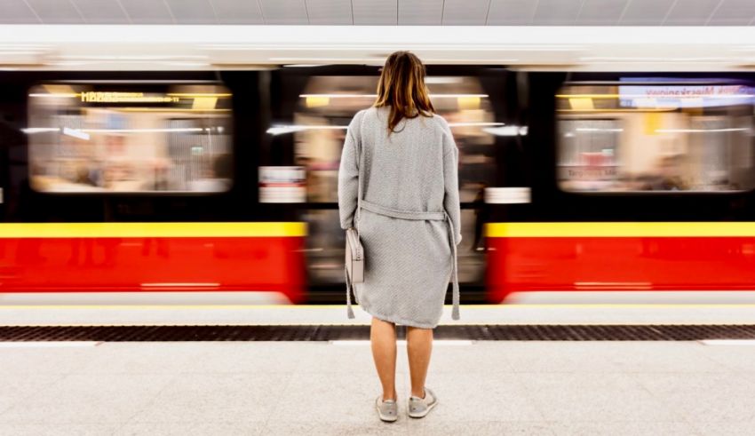 A woman standing in a subway station.