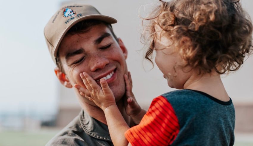 A man with a hat and a little girl holding his hand.