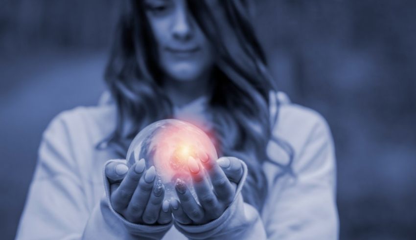 A woman holding a crystal ball in her hands.