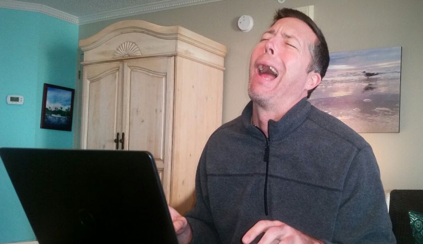 A man is yelling at his laptop.