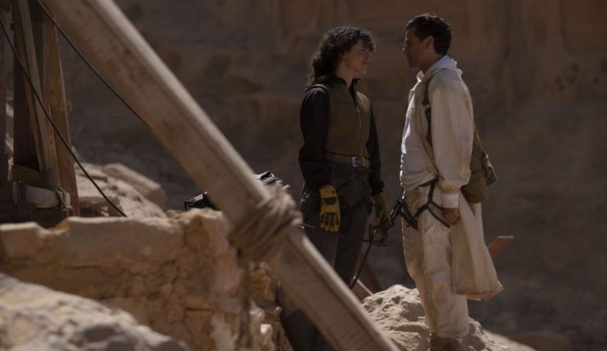 A man and a woman standing in a rocky area.