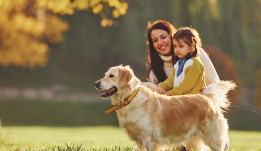 A woman and a child with a dog in a park.