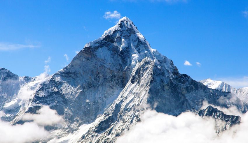 An image of a mountain covered in snow and clouds.